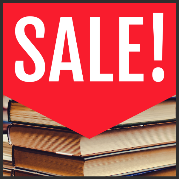 Red sign with the word "SALE!" above a stack of books.